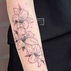 a woman's arm with flowers on it