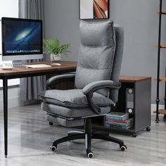 an office chair sitting in front of a computer desk with a monitor and keyboard on it