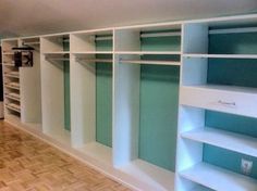 an empty walk - in closet with shelves and shelving units on the wall,