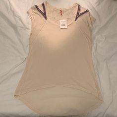 Nwt Free People Oatmeal Color Tee With Colorful Appliqu Accent On The Back And Shoulders. Very Comfortable And Perfect For Spring Or Summer! Casual Cream V-neck Top, Casual Oatmeal Tops For Summer, Casual Oatmeal Summer Tops, Cream Scoop Neck Tops For Spring, Cream Stretch Tops With Short Sleeves, Cream Stretch Short Sleeve Tops, Oatmeal Color, Accent Colors, Free People Tops