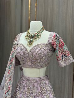 Our Mauve Purple Luxury Collection Bridal Wear Lehenga BWL-159 will make you feel like royalty on your special day. This elegant lehenga features a luxurious mauve and purple embroidered design perfect for any wedding, with intricate beading and delicate handiwork to create a timeless look. Its luxurious fabric is soft and comfortable, making this piece a perfect choice for a grand entrance. Complemented with Similarly embroidered blouse and net dupatta. Fabric: Net with raw silk lining WASH CAR Traditional Lavender Sets With Intricate Embroidery, Traditional Lavender Set With Intricate Embroidery, Purple Sharara With Intricate Embroidery For Reception, Elegant Purple Lehenga With Dupatta, Lavender Lehenga With Intricate Embroidery For Party, Festive Lavender Lehenga With Intricate Embroidery, Lavender Traditional Wear With Dupatta For Wedding, Elegant Lavender Dupatta For Reception, Fitted Lavender Wedding Set