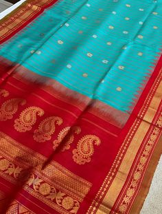 Pure Gadwal silk saree comes with blouse piece. Fall and pico done. Ships from USA. Step into timeless elegance with our exquisite handloom Gadwal silk saree, a true masterpiece crafted by skilled artisans. This luxurious saree features pure silk fabric, renowned for its soft texture and regal drape. The highlight of this saree is its intricately woven zari border, which adds a touch of opulence to the traditional design. Key Features: - 100% Pure Handloom Gadwal Silk - Richly Detailed Zari Bord Traditional Turquoise Wear With Zari Weaving, Turquoise Handloom Saree For Festivals, Traditional Turquoise Saree With Zari Weaving, Turquoise Saree With Cutdana For Puja, Turquoise Silk Saree With Zari Weaving, Turquoise Silk Saree With Pallu Detail, Turquoise Saree With Pallu For Puja, Traditional Turquoise Saree For Festivals, Turquoise Handloom Traditional Saree