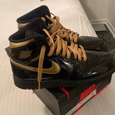 Black And Metallic Gold Jordan 1 Sneakers Gold Jordan 1, Black And Gold Jordans, Jordan 1 Colors, Nike Shoes Black, Jordan 1 Sneakers, Black Nike Shoes, Black Sneakers, Kids Nike, Nike Black