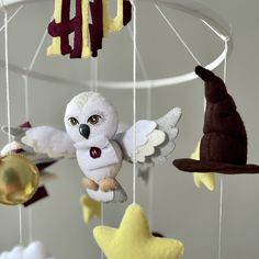 a mobile with stuffed animals hanging from it's sides and stars on the bottom