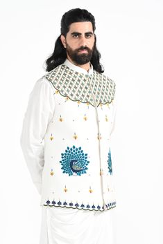 A dewy mist coloured Rajasthani inspired peacock motif hand embroidered nehru jacket with a cowl draped kurta made of bamberg raw silk. Paired with white slim fit Pant Pajama. Color of the actual garment may vary due to lighting conditions during the shoot.

Size Chart For Men





	
	
					Men's Size Chart
		

		
		
						
				Size Chart For Men
				Custom Size Measurement Guide
			
			
				
				
				Custom Size Measurement Guide
1. Take your measurements at ease…don’t hold your breath!
2. Be a Traditional Bandhgala For Designer Wear In Spring, Designer Nehru Jacket With Chikankari Embroidery In Raw Silk, Designer Embroidered Nehru Jacket In Raw Silk, Traditional Embroidered Outerwear For Diwali, Traditional Silk Bandhgala For Spring, Fitted Nehru Jacket With Multicolor Embroidery, Designer Embroidered Cotton Nehru Jacket, Ceremonial Cotton Bandhgala For Transitional Season, Diwali Traditional Cotton Nehru Jacket