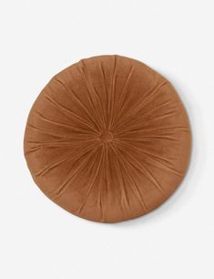 a brown round cushion on a white background