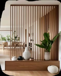 a living room with wooden slats and white vases