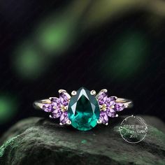 a green ring with purple stones on top