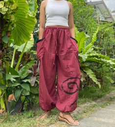 "The harem style trousers made from cotton fabric 100%with an elasticated smock waist and ankles they provide a comfortable lightweight fit, perfect for casual wear, festivals, yoga, holidays as well as pairing with a plain top to get that popular look. Materials: Cotton Sizing: One size fits most. Size : (inches) ✿Waist : 22-42 inch ( 55-106 cm ) ✿ Hip :up to 49 inch ( 124 cm) ✿ Length 40\" ( 101 cm ) ✿2 sides pockets S I Z E : US SIZE 4 - 12 , UK SIZE 8 - 16 , EU SIZE 36 - 44 MODEL SIZE : size Cotton Hippie Harem Pants With Pockets, Casual Cotton Harem Yoga Pants, Bohemian Baggy Harem Pants With Pockets, Baggy Hippie Harem Pants With Elastic Waistband, Baggy Harem Pants With Elastic Waistband In Hippie Style, Hippie Baggy Harem Pants With Elastic Waistband, Hippie Harem Pants With Elastic Waistband, Cotton Harem Parachute Pants With Pockets, Festival Harem Pants With Elastic Waistband