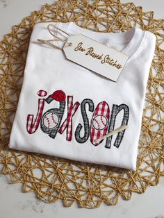 a white t - shirt with the word mason on it sitting on a doily