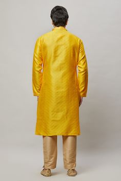 Brocade self embossed kurta with minimal gold embroidery on the placket and contrasting churidar Crafted with a collar neckline, full sleeves, and front hook closure. Occasion: Can be worn to lighter events like Mehendi, Puja, or a small party WASH CARE INSTRUCTIONS - Please Dry clean only when it is applicable. Slight color variation is possible due to digital photography. Yellow Long Sleeve Churidar For Festive Occasions, Long Sleeve Salwar Kameez With Self Design For Puja, Straight Kurta With Resham Embroidery For Winter, Winter Straight Kurta With Resham Embroidery, Fitted Long Sleeve Kurta For Puja, Long Sleeve Nehru Jacket For Eid, Long Sleeve Nehru Jacket With Dabka For Puja, Winter Straight Kurta With Zari Work, Long Sleeve Nehru Jacket For Diwali Puja