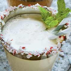 the drink is garnished with candy canes and sprinkled with mint