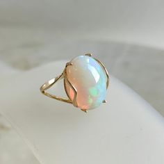 This stunning ring is set in 14k Solid Yellow Gold with Natural Ethiopion Opal with utmost precision. It is an unique statement gemstone ring for nearly every occasion and is completely hassle-free jewelry. ITEM DETAILS * GEM: Opal * GEM SIZE: 12X16mm * GEM SHAPE: Oval * GEM WEIGHT: 5.80 carats * Gold Purity: 14KT * Gold Weight: 1.64 gram * Total Weight of the Ring: 2.80 gram The Gold purity is guaranteed and it comes with authentic 14KT gold hallmark. Since my items are handmade, they are absol Fine Jewelry 14k Gold Opal Ring With Polished Finish, 14k Gold Opal Ring With Polished Finish, Fine Jewelry 14k Gold Opal Ring, 14k Gold Opal Ring Fine Jewelry, Formal 14k Gold Opal Ring, Fine Jewelry Polished Opal Ring, Oval Opal Ring With Prong Setting In 14k Gold, 14k Gold Opal Ring With Prong Setting, Dainty Opal Ring