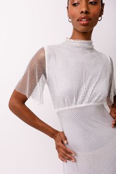 This maxi dress boasts a sheer mesh fabric, half sleeves, and a refined high neckline. The entire dress is adorned with shimmering rhinestone embellishments, adding an aura of luxury and sophistication. SIZE & FIT Sheet: 100% Polyester. 20% Polyester, 40% Plastic. Fishnet Texture, Metallic Trousers, Dress Half Sleeve, Embellished Maxi Dress, Dress Slim, Rhinestone Embellishments, Half Sleeve Dresses, Pearl Jewellery Earrings, Halterneck Dress