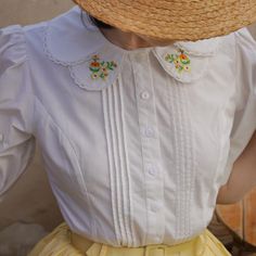 A retro blouse with small brightly blooming flowers embroidered on the collar. The design has pleats on the chest and bulges on the shoulders. It will make you look like a pure and gorgeous lady. The retro and adorable atmosphere makes your heart beat faster just by wearing it. 
 
 Size 
 
 
 S size 
 
 Length: 57cm 
 Shoulder width: 34cm 
 Bust: 91cm 
 Sleeve length: 33cm 
 
 M size 
 
 Length: 58cm 
 Shoulder width: 35cm 
 Bust: 95cm 
 Sleeve length: 34cm 
 
 L size 
 
 Length: 59cm 
 Shoulder Cute Spring Blouse With Peter Pan Collar, Floral Embroidery Doll Collar Blouse For Summer, Summer Floral Embroidery Doll Collar Blouse, Floral Embroidered Doll Collar Blouse For Summer, Summer Blouse With Floral Embroidery And Doll Collar, Spring Embroidered Blouse With Peter Pan Collar, Cottagecore Tops With Peter Pan Collar For Summer, Cottagecore Summer Tops With Peter Pan Collar, Cottagecore Peter Pan Collar Top For Spring