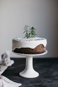 a cake with frosting and sprinkles sitting on top of a table