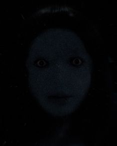 the face of a woman in the dark