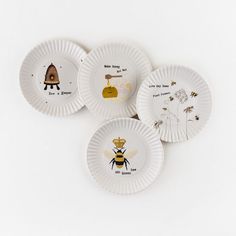 three paper plates with bee designs on them