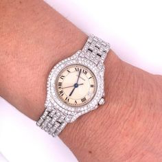 Vintage Women's 18 karat white gold Cartier watch with quartz movement and original Cartier factory diamonds. Movement Caliber 687, water-resistant, and set with over 3 carats in round-cut diamonds.   Stamped: "Cartier", "Quartz", "18K", "387907 000180", and "Swiss made".   Watch: - Brand: Cartier  - Style: Ballon - Gender: Ladies  - Movement: Quartz  - Water-Resistant (1 ATM) - Serial #: 387907 000180 - Weight: 70.00 grams - Caliber 687  Case/Dial:  - Case Material: 18k White Gold - Hour Markers: Roman Numeral  - Dial Color: White  - Case Width: 28mm  - Bezel Material: 18k White Gold - Crystal: Scratch-resistant sapphire crystal   Bracelet:  - Closure: Double Fold Over Clasp (Hidden) - Length: 7 inches  - 18k White Gold   Diamonds: - Total Carat Weight: 328 diamonds, 3.28 carats total (ap Cartier Diamond Watch With Round Dial, Cartier Diamond Watch With Diamond Accents, Cartier Diamond Watch White Gold 17 Jewels, Formal Diamond Jewelry With Vvs Clarity, Cartier Diamond Watch With Brilliant Cut, Classic Diamond White Round Diamond Watch, Elegant Cartier Watch With Brilliant Cut, Cartier Diamond Watch For Wedding, Diamond Watch With Brilliant Cut