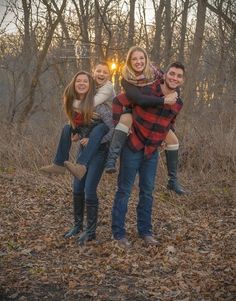 a group of people are posing for a photo in front of some trees and leaves