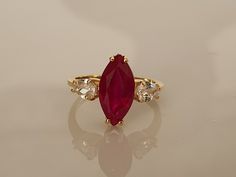 Express Shipping 3-5 Days with UPS PRODUCT DESCRIPTION Marquise Engagement Ring, Marquise cut Ruby Ring, Ruby Rings for Women, Red Ruby Ring, Engagement Ring, Promise Ring This gorgeous 14K Gold Filled Over 925 sterling silver Lab. Ruby ring The stones are set in a solid .14K Gold Filled Over 925 sterling silver size 4-16 USA. Please note, ring process 5-8 business days. All of our items are shipped in a complimentary gift box. Main Stone: Lab. Ruby Size: 13 x 7 mm Cut: Marquise Cut Metal:14K Go Red Ruby Ring Vintage, Luxury Marquise Cut Ruby Ring, Ruby Ring Marquise, Engagement Rings With Rubies, Gold Ring Red Stone, Red Stone Ring Women, Unique Ruby Engagement Rings, Gold Ring With Stone, Ruby Stone Ring