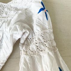 "I love vintage Mexican wedding dresses. They are always so lovely with the lace details. Those with embroidery are even prettier. This 50s/60s beauty has an assortment of colorful flowers scattered throughout. Back metal zip. Condition: Excellent. White is pristine. There is no color run from the embroidery. Some flowers have a little \"fraying\" from the threads - very very minor and barely noticeable. Label: None. Well made. Bust 35/36\" Waist 29-32\" Hips 57\" Length 55.5\" This item has bee Vintage Spring Dresses With Intricate Embroidery, Vintage Summer Dresses With Intricate Embroidery, Vintage Dresses With Intricate Embroidery For Summer, Vintage White Embroidered Dress, Vintage White Dress With Lace Sleeves, White Retro Dress With Lace Trim, Retro White Dresses With Lace Trim, Retro White Dress With Lace Trim, Vintage Embroidered Lace Dress