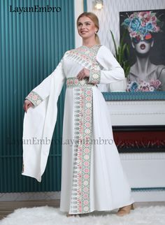 White Embroidered Kaftan For Eid, White Kaftan With Intricate Embroidery For Eid, Eid Gown With Multicolor Embroidery, Eid Embroidered Multicolor Gown, Eid Multicolor Embroidered Gown, Eid Multicolor Embroidered Maxi Dress, White Embroidered Maxi Gown, White Embroidered Maxi Length Gown, Floral Embroidered Abaya For Eid Wedding