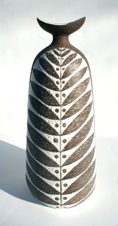 a black and white vase sitting on top of a table