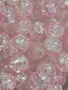 some pink and white beads are in a bowl