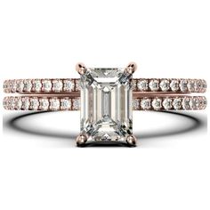 an emerald cut diamond ring with two rows of diamonds on the band and side stones