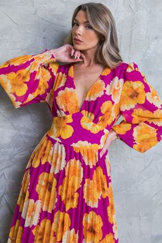 Look effortlessly stylish in this printed floral dress. Featuring a V neckline, long sleeves with smocked cuffs, a waist yoke, pleated skirt, and smocked back waistband, this midi dress is perfect for making a fashionable statement. DetailsSelf : 100% PolyesterLining : 100% Polyester Size & Fit - Model is 5`8" And Wearing Size Small- Measurements Taken From Size Small- Approx. Length: 49" Floral Pleated Skirt, Flying Tomato, Home Dress, 70 Dress, Vintage Inspired Design, Pleated Midi Skirt, Floral Print Dress, Pleated Skirt, Floral Dress