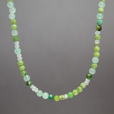 "An array of dainty Jade, Aventurine, Chrysoprase and faceted Idocrase and Prasiolite gems form this beautiful necklace.  These soft shades of pale green are perfect for spring and summer!  28 inches long and fastens with a simple sterling silver lobster clasp.  Genuine 2mm and 3mm facted Idocrase and Prasiolite Genuine 4mm Nephrite Jade, Aventurine, and Chrysoprase 925 Sterling Silver Findings 28\" Long Artisan made in Texas, USA Arrives thoughtfully packaged in a signature kraft jewelry box" Green Faceted Spiritual Jewelry, Spiritual Green Faceted Jewelry, Green Emerald Necklace For Jewelry Making, Jade Necklaces With Natural Stones For May Birthstone, Green Jade Stone Necklaces, Green Jade Necklaces With Stones, Emerald Necklace With Chrysoprase Gemstone Beads, Emerald Necklace With Chrysoprase Round Beads, Green Gemstone Beads Crystal Necklace For Healing