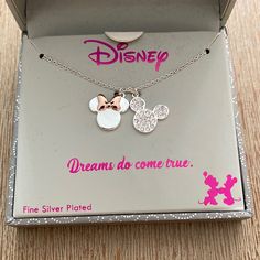 the disney mouse and minnie mouse necklace is in its box