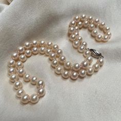 A beautiful Japanese Akoya pearl necklace on a 9ct white gold clasp.  * 6mm lovely quality cultured Akoya pearls * 9ct white gold safety hook clasp * hand knotted throughout  * 18" / 45cm length High quality pearl necklace, full of softly lustred, creamy cultured pearls that have lots of pink tones within their nacre. With the finishing double sided 9ct white clasp, this necklace looks gorgeous on any occasion. Perfect for brides, as a 21st birthday gift, a graduation present, a 30th wedding ann Silver Akoya Pearl Necklace With Sterling Silver Clasp, Single Strand Akoya Pearl Bracelet In Pearl White, Classic White Gold Pearl Necklace For Anniversary, Single Strand Pearl Bracelet, Delicate White Pearl Necklace For Formal Occasions, Elegant Single Strand Cream Pearl Necklace, Elegant Cream Single Strand Pearl Necklace, Elegant Cream Single Strand Necklace, Classic Pearl Necklace Gift