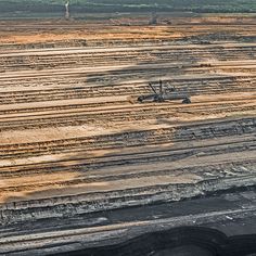 an aerial view of a construction site with machinery and dirt in the foreground,