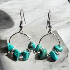 These beaded hoop earrings are made with turquoise jasper nuggets and silver  beads and accented with silver plated wires. The earrings measure 2 inches (5.08 cm) in length.   I ship internationally to anywhere in the world and your earrings will come in protective packaging.   Please see my Policy page for further information: http://www.etsy.com/shop/KNITTEDLtd/policy?ref=shopinfo_policies_leftnav Want to see more of my earrings, click here:  www.etsy.com/shop/KNITTEDLtd Turquoise Dangle Hoop Earrings Wire Wrapped, Turquoise Wire Wrapped Dangle Hoop Earrings, Nickel-free Turquoise Metal Hoop Earrings, Turquoise Dangle Hoop Earrings Nickel Free, Nickel-free Turquoise Dangle Hoop Earrings, Dangle Hoop Earrings, Protective Packaging, Beaded Hoop Earrings, Jasper Beads