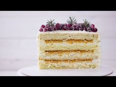 a layered cake with cranberries and pineapples is on a white plate