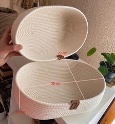 two white baskets sitting on top of a table