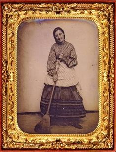 an old photo of a woman with a broom