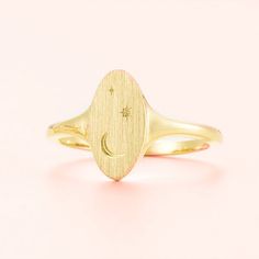 Adorn your finger with the Celestial Signet Ring, a unique and inspiring piece crafted in 14k gold or silver. Featuring a striking moon and stars motif, this celestial ring is a piece of art that reflects your own unique style and shines with high-quality. Make a statement with this stunning accessory!RING LAYOUT  Ring Width: 13 mm tapered to 2 mm Ring Sleeve:14KGold or Sterling Silver Ring Profile:Round Ring Finish:Brushed Top, Polished Shank Celestial Ring, Engraved Wedding Rings, Colored Engagement Rings, Round Rings, Moon And Stars, Engraved Rings, Accessories Rings, Signet Ring, Custom Rings