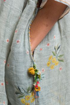 a close up of a woman's shirt with flowers on it