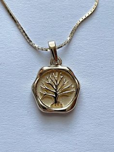 This is a simply stunning vintage 14 karat yellow gold Tree of Life or Tree of Long Life  pendant necklace. The necklace chain is a box chain that measures 16 inches. It is hallmarked 14 KT Italy The pendant measures 3/4"  long including the bale and is 1/2"  wide. The backside is engraved Long Life.  It is Hallmarked 14 K along with a makers mark of the letters C & W in circles that are interlocked.  The necklace and chain together way 4.9 g. This item is in excellent preowned vintage condition Tree Of Life Necklace Gold, 14k Gold Medallion Necklace With Box Chain, 14k Gold Box Chain Necklace For Anniversary, Box Chain Medallion Necklace As Gift, Medallion Box Chain Necklace As Gift, Timeless Necklace Stamped 14k As Gift, Heirloom Gold Necklace With Hallmark, Timeless 14k Stamped Gold Necklace As Gift, Classic 14k Gold Necklace For Memorial