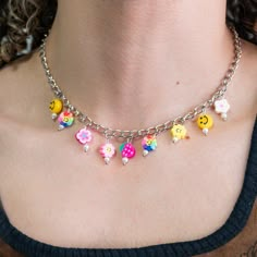 a woman wearing a necklace with charms on it