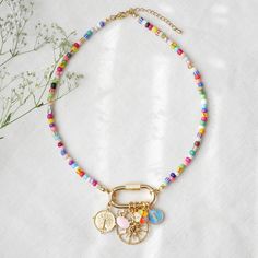 Colorful beaded carabiner necklace is such a unique seed bead necklace with your choice of gold and colorful charms! In this necklace, I have paired small (4 mm) colorful glass seed beads beads with a large 14k gold plated carabiner lock and your choice of charms. The carabiner lock opens so you can also add your favorite charms. The length of the necklace is 16 inches, with 2 inches extension chain so you can adjust the necklace between 16 and 18 inches (40 - 46 cm). Gold-plated and stainless s Beaded Carabiner, Carabiner Necklace, Custom Charm Necklaces, Blue Charm, Custom Charms, Seed Bead Necklace, Beaded Jewelry Diy, Bead Necklace, Seed Bead