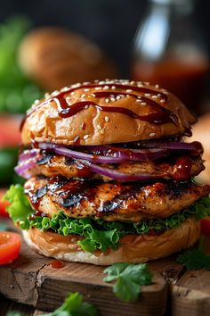 a chicken burger with lettuce, onions and sauce