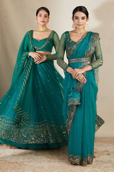 Teal green attached can can lehenga with floral embroidery in sequin, cutdana and nakshi. Paired with embroidered, padded blouse and embroidered border dupatta.
Components: 3
Pattern: Embroidered
Type Of Work: Nakshi, Cutdana, Sitara
Neckline: Sweetheart
Sleeve Type: Sheer
Fabric: Nylon, Net, Crepe
Color: Green
Other Details: 
Floral pattern
Lehenga Length: 44 inches
Note: Saree set and potli bag held by the other model is not for sale
Occasion: Bride,Wedding - Aza Fashions Embroidered Pista Green Pre-draped Saree For Reception, Green Embroidered Pre-draped Saree For Reception, Green Choli For Reception With Traditional Drape, Green Designer Party Wear Sets, Transitional Green Dola Silk Choli, Green Dola Silk Pre-draped Saree For Reception, Green Choli With Cutdana For Reception, Party Wear Green Lehenga With Resham Embroidery, Green Choli With Zari Work For Transitional Season