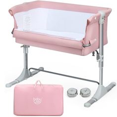 a pink baby crib next to a bag and some shoes on a white background