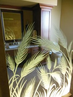 the reflection of a palm tree in a mirror with light shining on it's side