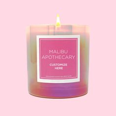 a candle that is sitting on a pink background with the words maubu apothecary