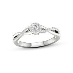 a white gold ring with diamonds in the shape of a heart on top of it